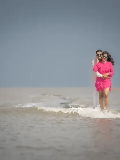 A playful and candid shot of a couple enjoying the waves during their pre-wedding photoshoot. It's these fun, unscripted moments that I love to capture.