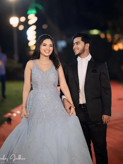 A happy couple walking hand-in-hand. The bride's princess gown and radiant smile make for a perfect fairytale picture.