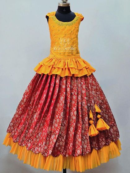 A layered gown in yellow and red. The skirt is a beautiful red brocade, and the top has modern ruffles.