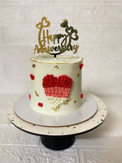 A lovely strawberry anniversary cake with a textured heart and a touch of gold.