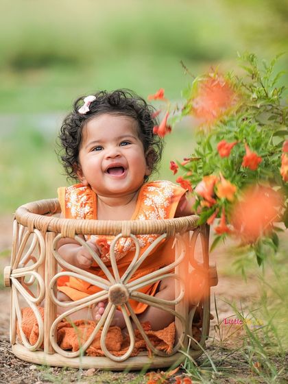 The purest joy captured in an outdoor setting. This baby girl's happy laugh while sitting in a basket among flowers is simply heartwarming.
