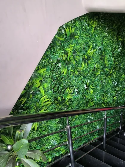 A closer look at the artificial green wall along the staircase at Corfit gym. The vibrant green adds a touch of the outdoors and makes the space feel more dynamic.
