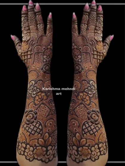 Another example of a heavy Indo-floral design, this mehendi features layers of intricate patterns from the elbow to the fingertips. The symmetrical layout ensures a balanced and cohesive look.