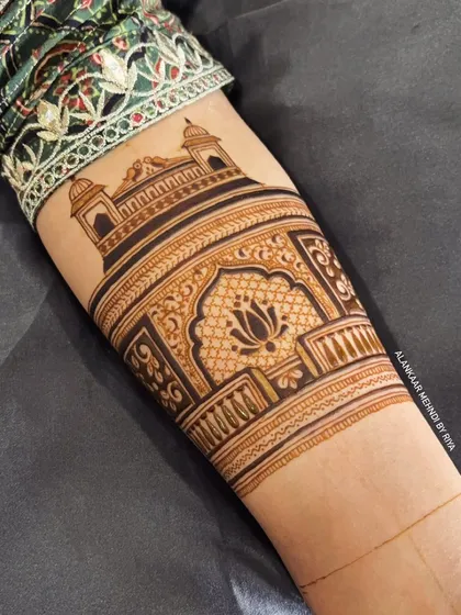 A beautiful bridal arm band design featuring a lotus motif inside a traditional Indian arch.