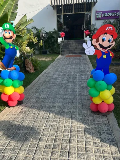 Life-sized Mario and Luigi cutouts greet guests at the entrance, setting the tone for a fun-filled gaming adventure.