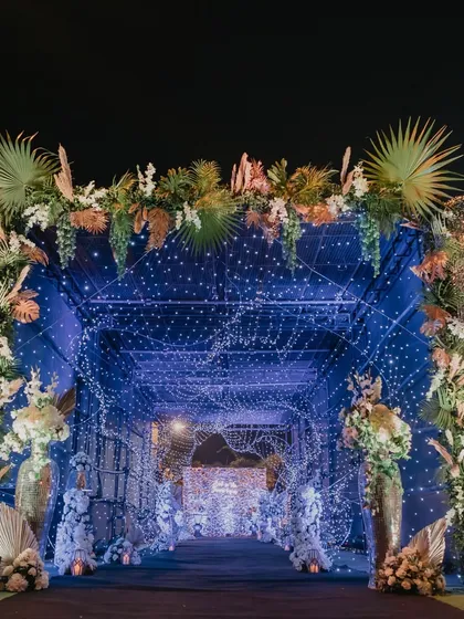 A magical entrance tunnel made of sequin panels and thousands of fairy lights, leading guests into the Sangeet party.