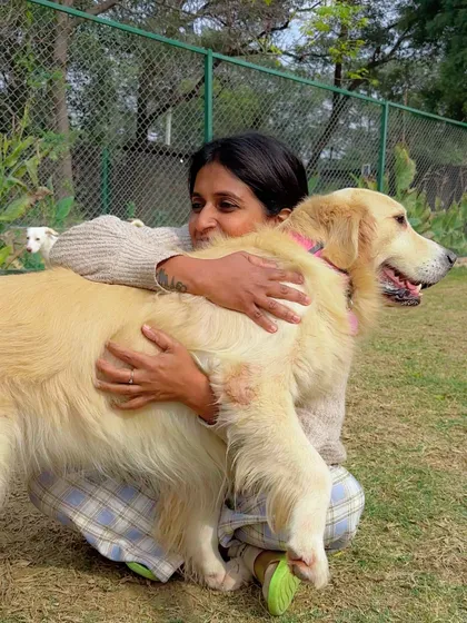 The bond of trust knows no size or breed. Here, my partner Asha shares a hug with a gentle Golden Retriever, showing the deep affection and mutual respect that is the hallmark of our care. Every animal is met with patience and understanding.