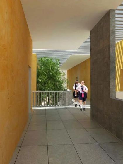 An indoor-outdoor corridor that opens onto a balcony, connecting students with fresh air and greenery. The design prioritizes natural ventilation and visual connections to the outside, key elements of biophilic school design.