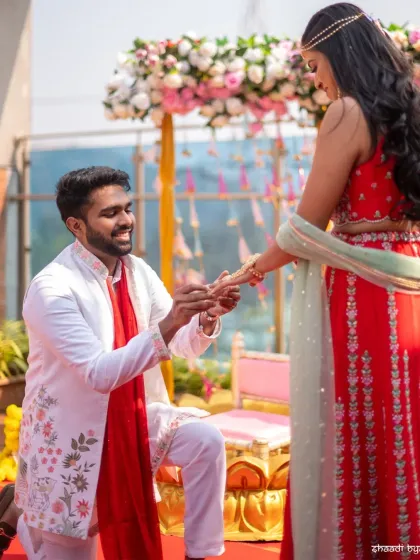 A romantic gesture as the groom gets down on one knee during the Mehendi ceremony.