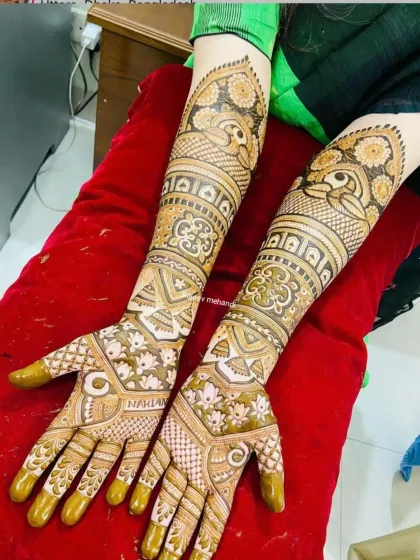 A beautiful example of a non-portrait design, this mehendi features graceful peacocks and intricate floral and geometric patterns.