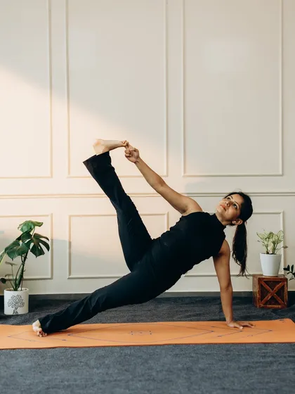 Vasisthasana (Side Plank) variation, where the practitioner holds the big toe. This advanced pose demands immense core strength, balance, and hamstring flexibility, showcasing a beautiful expression of stability and openness.