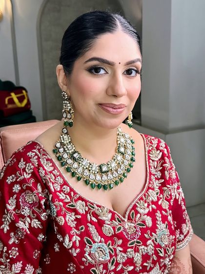 A beautiful portrait of my stunning bride Radhika. For her look, I focused on creating a soft, glowing base with subtly smoked-out eyes and a neutral pink lip to balance her magnificent green and white kundan jewelry.