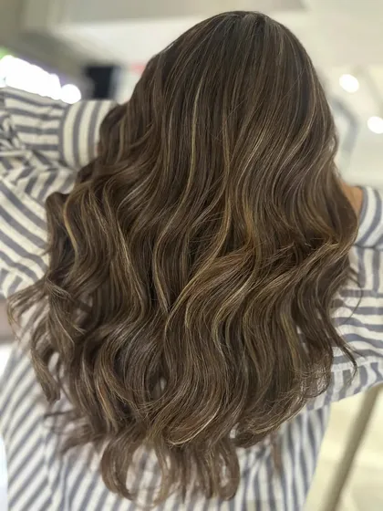 These two-tone highlights on a cool brown base provide 100 percent grey coverage. It's a beautiful way to blend greys for a natural, youthful look.