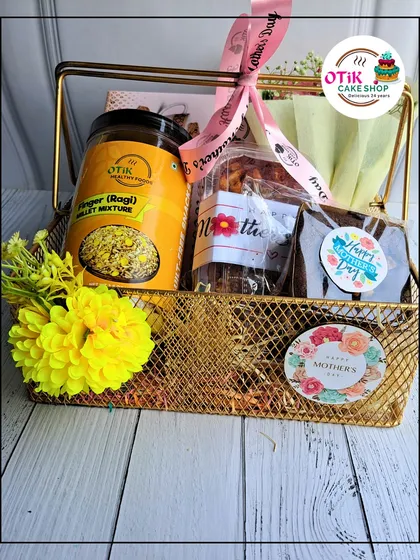 This elegant golden wire basket is a popular choice for Mother's Day. It's filled with a mix of treats, including a jar of healthy ragi millet mixture and fudgy brownies.