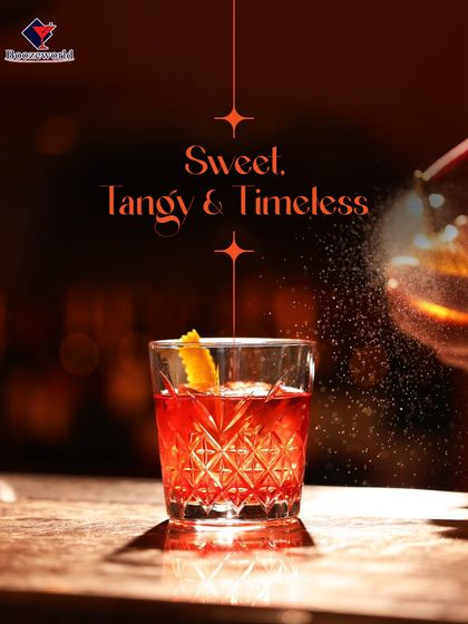 A timeless classic, this Negroni-style cocktail glows with a deep red hue. The orange peel garnish adds a burst of citrus aroma, perfectly complementing the bittersweet flavors of the drink.