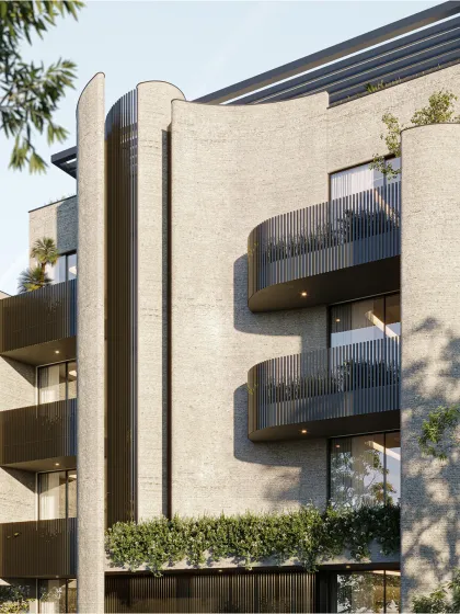 Pushing the boundaries of conventional design, this facade balances bold geometry with a gentle rhythm. Curved balconies and textured surfaces create a visual softness, while black metal railings introduce contrast and modernity.