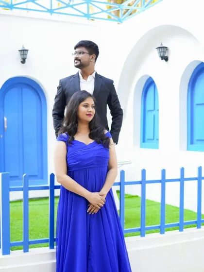 A stylish pose at our Santorini set. The clean white and blue background makes the couple's formal attire pop.