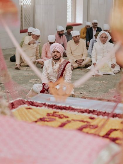 A unique perspective of the groom during the Sikh wedding ceremony, capturing the solemnity of the occasion.