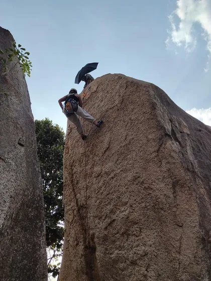 A climber rappels with an umbrella, a humorous take during a serious skills workshop. We always find ways to have fun while learning.