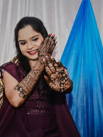 A happy bride showing off her engagement mehendi. Seeing my clients smile is the best part of my job. I work closely with each person to create a design that makes them feel special and beautiful for their big moments.
