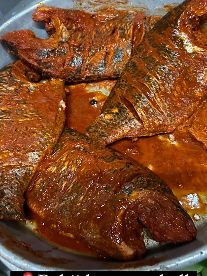 Fresh Tilapia fish marinating in our signature red tandoori masala. We ensure every fish is thoroughly coated in spices before it hits the hot oil, locking in all the juices and flavor.