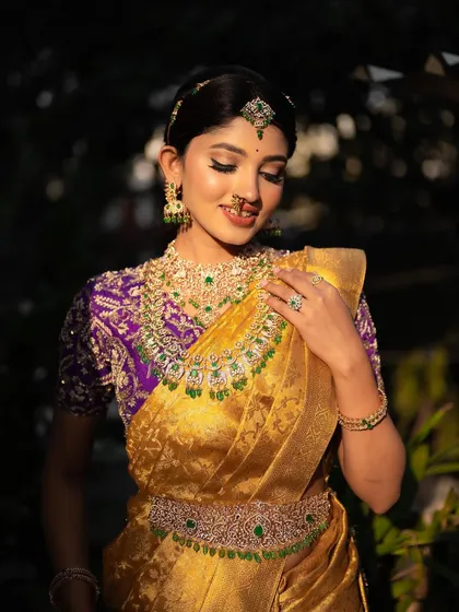 A sun-kissed portrait of actress Rachana Inder in a traditional bridal saree. The warm light highlights the intricate details of her jewelry and the rich texture of the fabric.