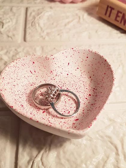 A close-up of our red speckled mini heart dish, a perfect little tray for your most-worn rings.