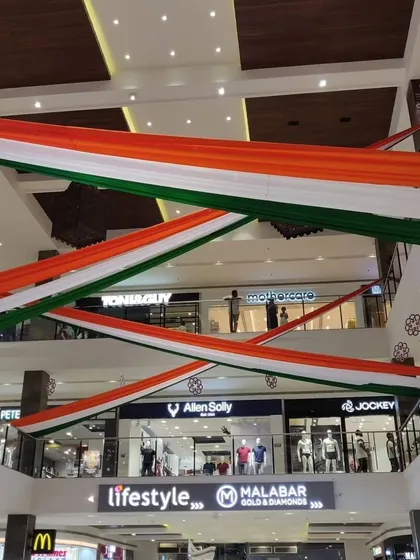 For this Independence Day project, we transformed a multi-level shopping mall with large, flowing tricolor fabric drapes. This shows our capability to handle large-scale commercial decoration projects, creating a patriotic ambiance that engages all visitors.