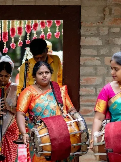 Traditional musicians playing the nadaswaram and thavil, providing a classic and auspicious soundtrack to a South Indian wedding.