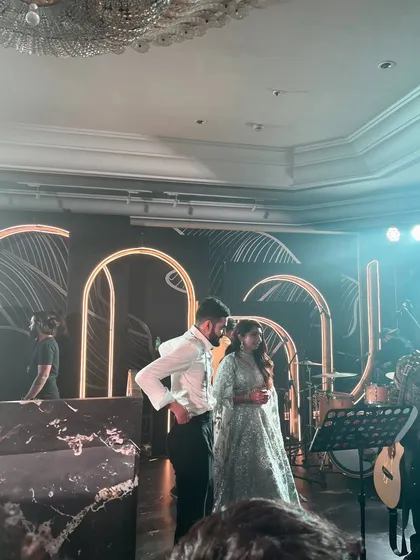 The bride and groom on stage at their elegant reception. We provide a complete beverage service that complements the sophistication of high-end wedding events.