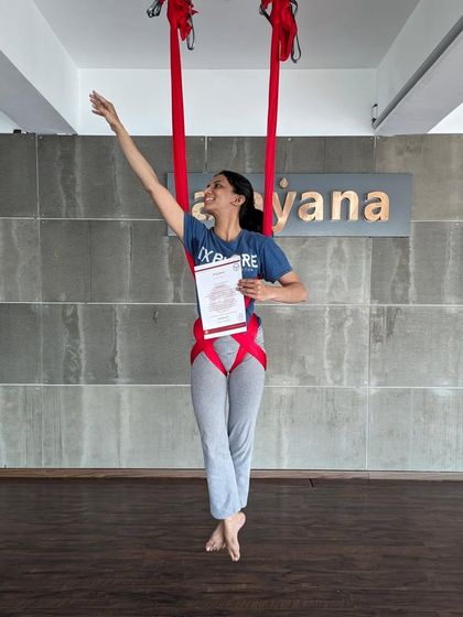 Reaching for the sky. A graduate celebrates her certification with an expressive pose.