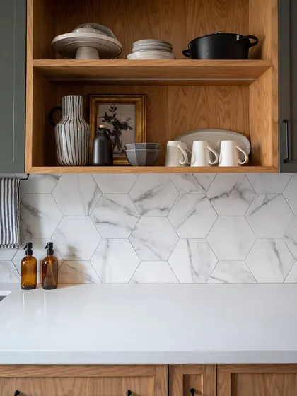 The open shelf in this kitchen is styled with a mix of practical and decorative items. This approach to open shelving keeps it from looking cluttered, instead turning it into a personal display that adds character to the room.