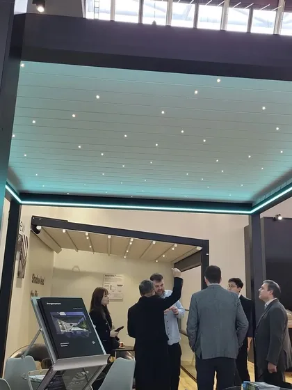 Examining a pergola with integrated "starlight" LED lighting at the R+T Expo. This is the kind of cutting-edge feature we look for to elevate our clients' outdoor living spaces.