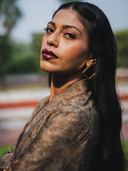 A powerful close-up of Anasuya Sengupta. Her confident expression and the warm outdoor light make for a stunning and engaging portrait.