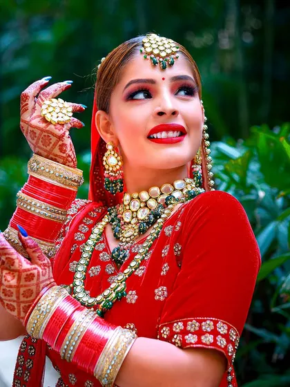 A celebratory and expressive pose that highlights the bride's personality and stunning wedding look.