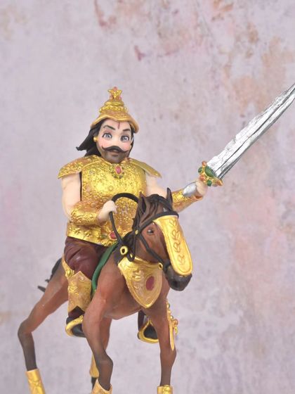 A full view of the Indian king cake that was part of my award-winning portfolio. The cake itself is designed to look like an ancient fort, with the hand-sculpted warrior and his horse as the majestic topper.