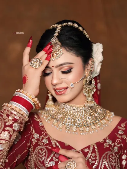 This shot captures the intricate details of the jewelry and how the makeup, especially the highlight, catches the light beautifully.
