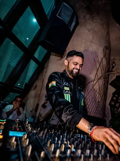 A smiling shot of me at the decks. Even during intense sets, I'm having the time of my life, and that energy is infectious.