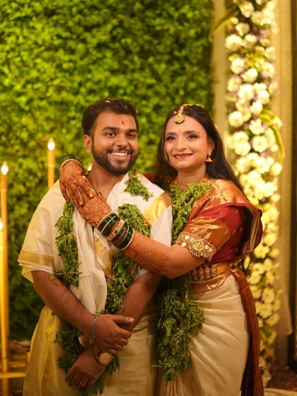 A lovely portrait of the couple after their temple wedding ceremony, surrounded by greenery.