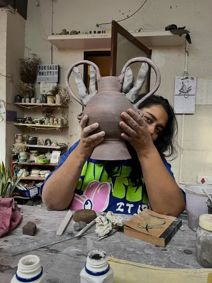 Here I am, peeking out from behind a new piece in the studio. This is my happy place, surrounded by mitti, works-in-progress, and endless possibilities. Every piece I make holds a little bit of this joy.