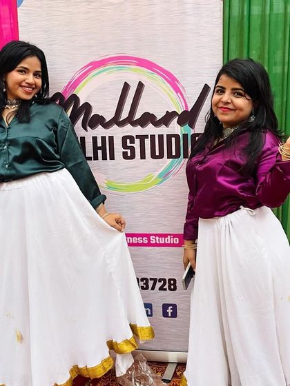 Posing with our studio banner after a successful Holi event. We are proud to represent the Mallard Delhi Studio community wherever we go.