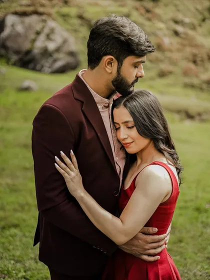 A gentle, loving hug in a green meadow in Manali, capturing a quiet moment of togetherness.