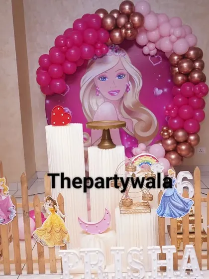 A full view of the Barbie theme party, complete with a welcome sign. The setup includes multiple character cutouts and a beautiful pink and rose gold color scheme that's perfect for photos.