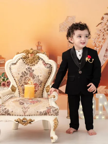 A dapper little gentleman. A classic black suit is a timeless choice for a first birthday or any special milestone.
