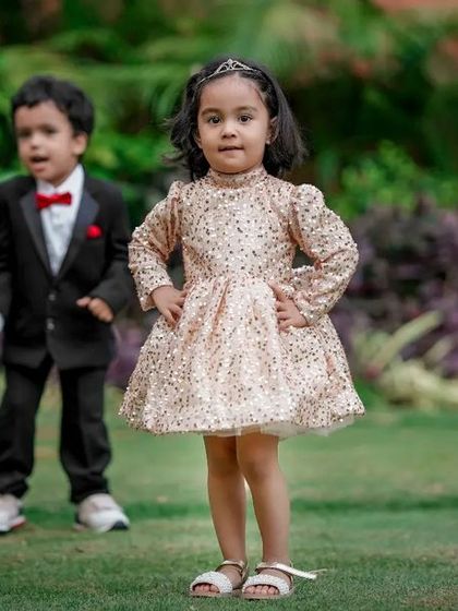 This little girl knows how to strike a pose! Her confident stance and her brother's candid expression make for a fun and memorable kids portrait.