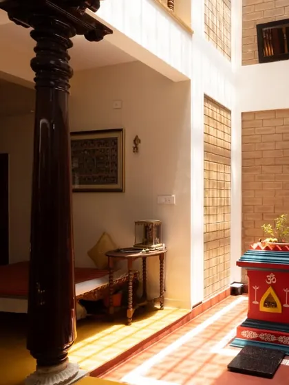 The spiritual heart of the home, this central courtyard features a Tulasi Katte, bathed in sunlight from a skylight. An antique wooden pillar stands as a silent witness, grounding the space in tradition and craftsmanship, creating a serene connection between the sacred and the everyday.