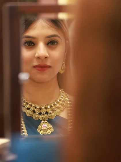 A creative shot using a mirror to frame the model's reflection. This adds an artistic and intimate feel to the jewellery shoot.
