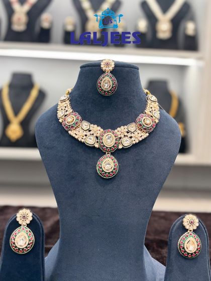 This polki necklace set with multi-coloured stones is a versatile choice for any wedding function. It comes with matching earrings and a maang tikka.