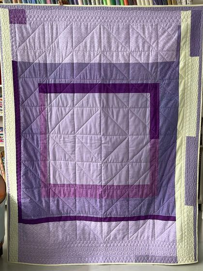 The back of the purple diamond quilt, with a modern, minimalist design.