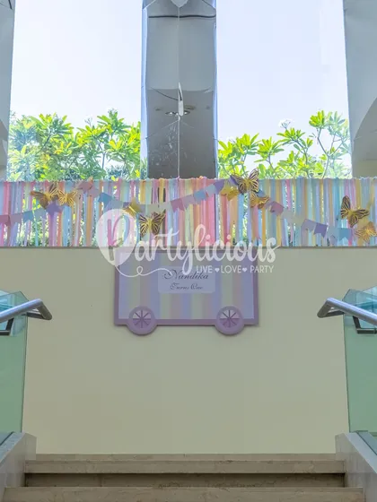 A whimsical welcome detail with pastel ribbons and golden butterflies, setting a magical tone from the moment guests arrive.